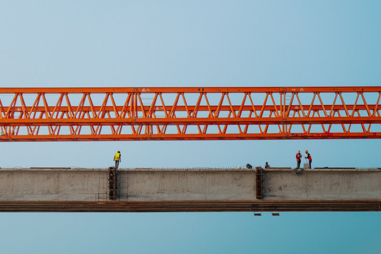 Services Workers and red crane on a bridge construction in Chilmari, Bangladesh.