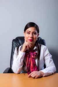 Portrait of a professional woman in an office setting, exuding confidence and poise.